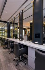 Row of workstations and mirrors at a hair salon