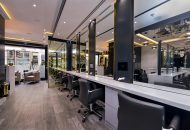 Row of workstations and mirrors at a hair salon