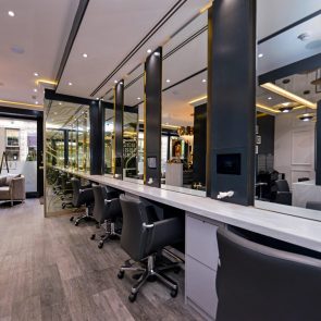 Row of workstations and mirrors at a hair salon