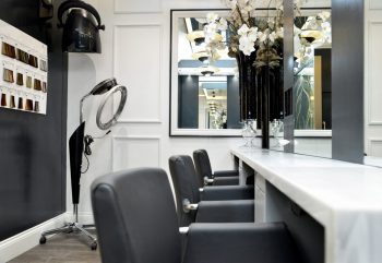 Styling area and workstations in a hair salon designed by Retail Experience Design